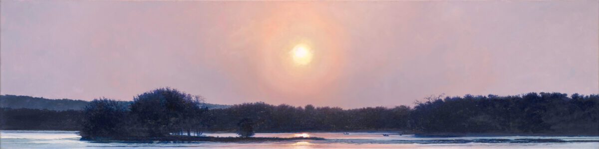 Sunset over a calm lake with silhouetted trees and a soft pink and purple sky reflected in the water.