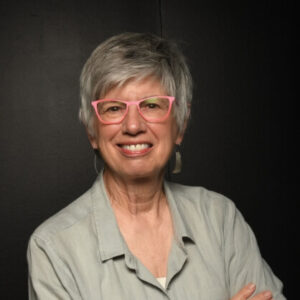 Janelle McClain standing against a dark background.